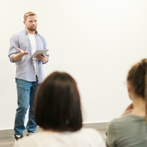 A person talking in front of a crowd.