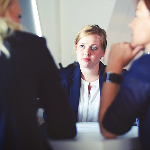 Person looking at two other people talking.